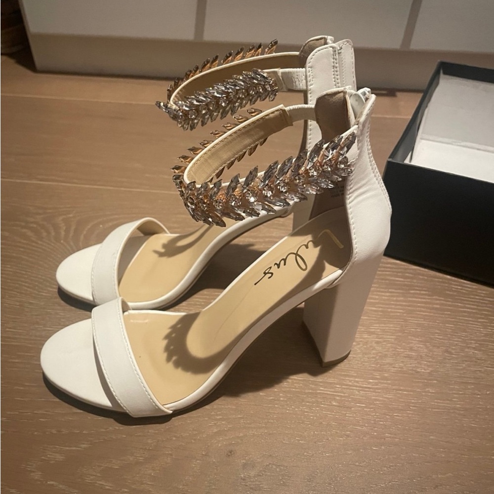 Elegant White Heeled Sandals with Silver Accents